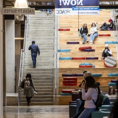 ACC Highland campus social staircase with students sitting on the staircase. 